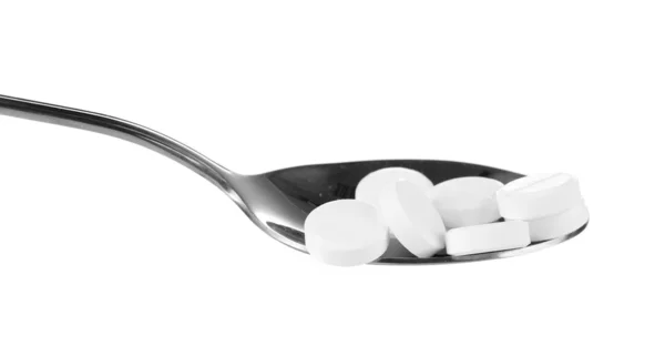 勺子与隔绝在白色的药片 — 图库照片