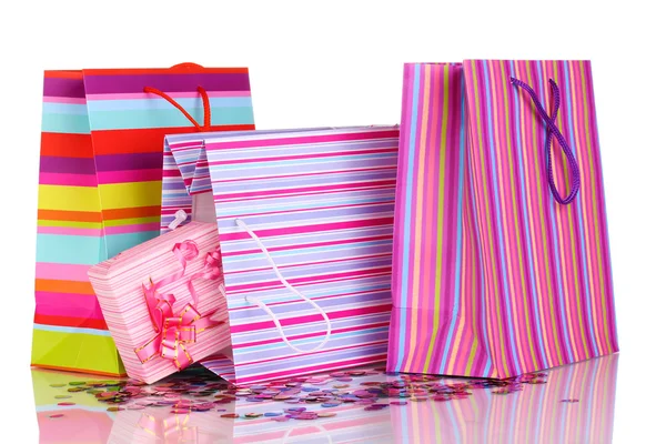 Colorful gift bags and gifts with confetti isolated on white — Stock Photo, Image
