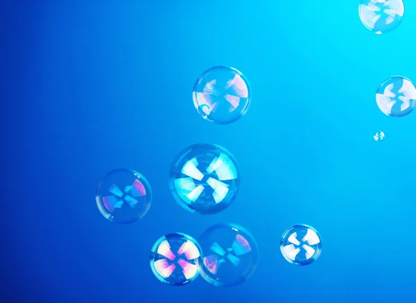 Soap bubble on blue background — Stock Photo, Image