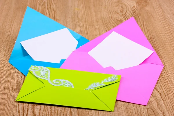Color envelopes on wooden background — Stock Photo, Image