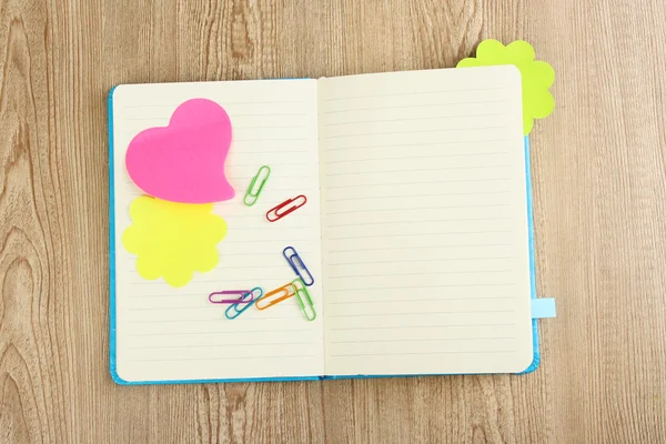 Open note book with stickies on wooden background — Stock Photo, Image