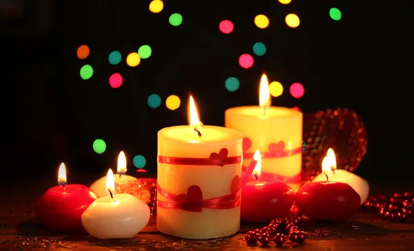 Beautiful candles on wooden table on bright background — Stock Photo, Image