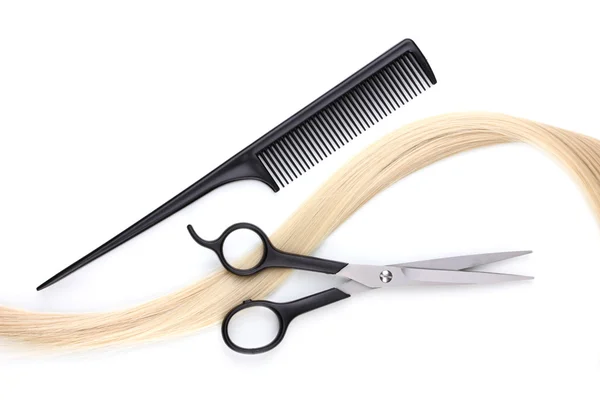 Shiny blond hair with hair cutting shears and comb isolated on white Stock Photo