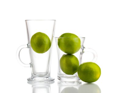 Fresh limes in glass cups isolated on white clipart