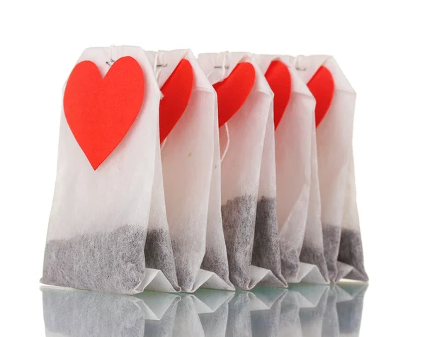 stock image Tea bags with blank heart-shaped labels isolated on white