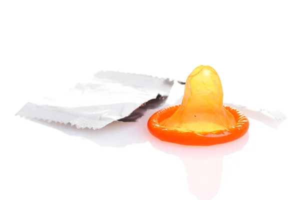 Orange condom with open pack isolated on white — Stock Photo, Image