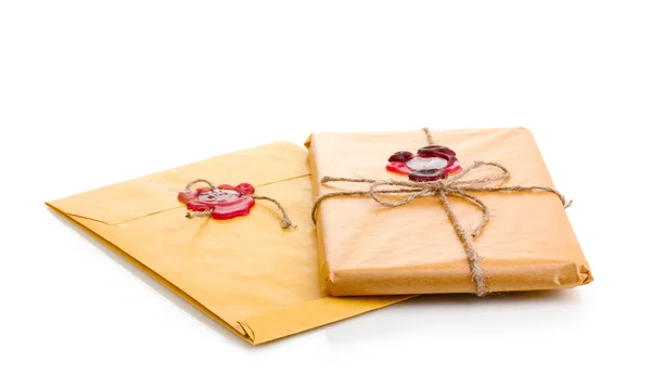 Parcel and envelope with sealing wax isolated on white — Stock Photo, Image