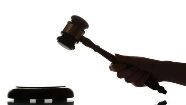 Wooden gavel in hand on gray background — Stock Photo, Image