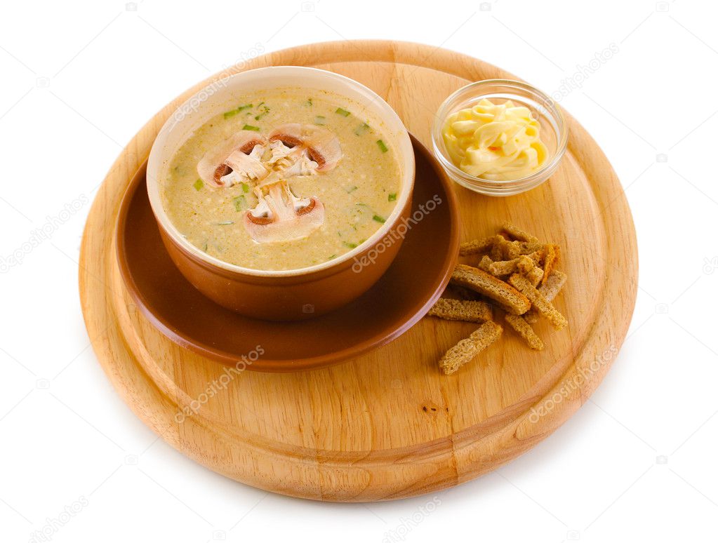 Tasty soup on wooden round board isolated on white