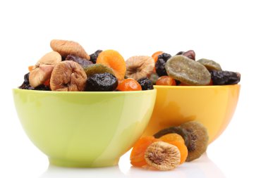 Dried fruits in bright bowls isolated on white