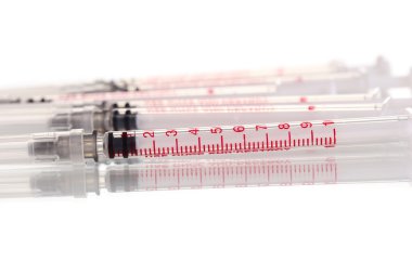 Insulin syringes isolated on white clipart