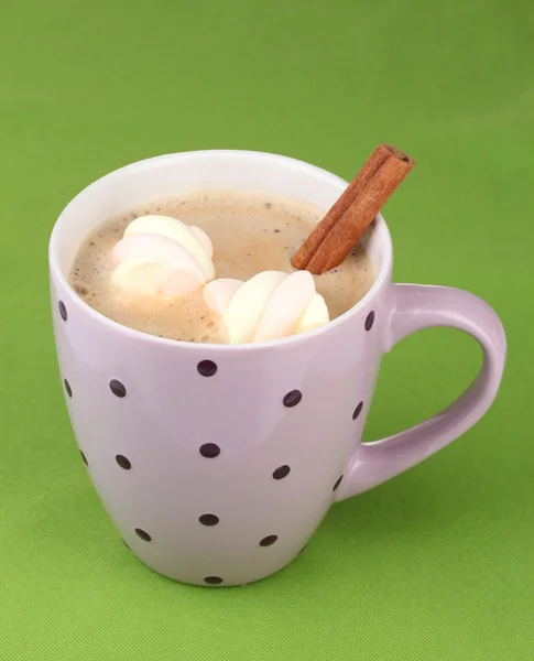 Xícara de cappucino com marshmallows e canela no fundo verde — Fotografia de Stock