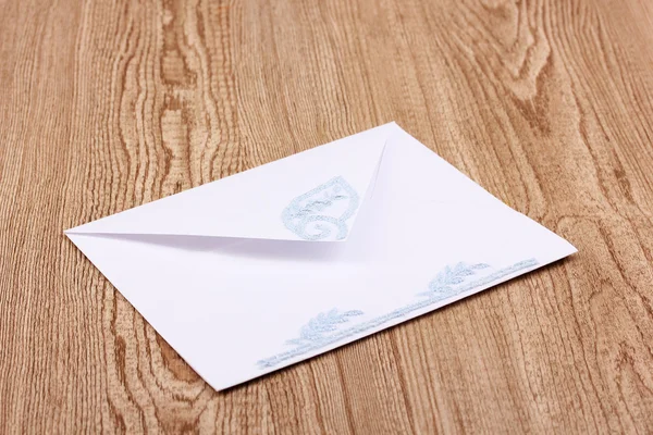 Белый конверт на деревянном фоне — стоковое фото