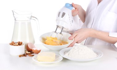 Female hands mixing eggs in bowl isolated on white clipart