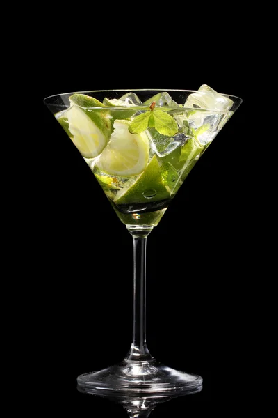 Verre de cocktail avec citron vert et menthe sur fond noir — Photo