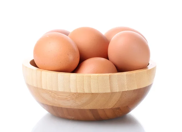 stock image Brown eggs in wooden bowl isolated on white