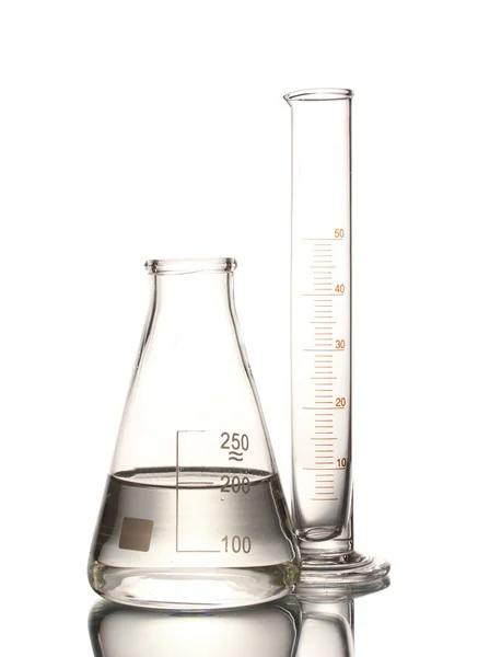 Flask with water and empty measuring beaker with reflection isolated on whi — Stock Photo, Image
