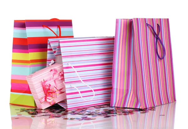 Colorful gift bags and gifts with confetti isolated on white — Stock Photo, Image