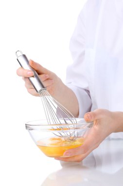 Female hands Mixing eggs in bowl isolated on white clipart