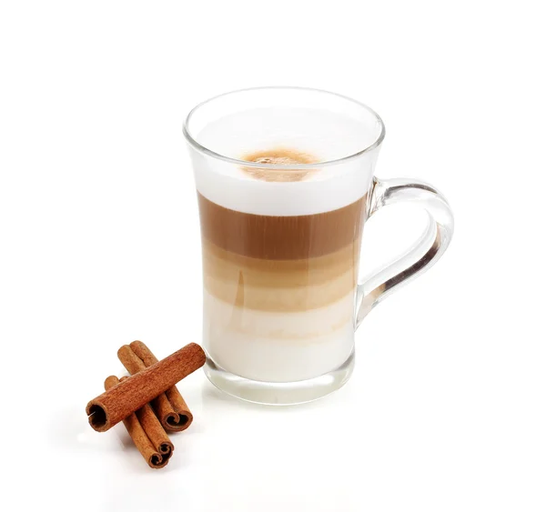 Fragrant сappuccino latte in glass cup and cinnamon isolated on white — Stok Foto