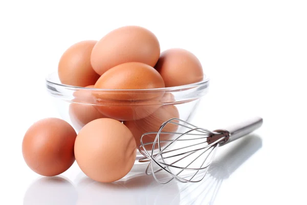 Metalowa Trzepaczka do ubijania jajek i brązowe jaja w miska na białym tle — Zdjęcie stockowe