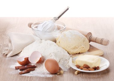 Ingredients for the dough wooden table on white background clipart