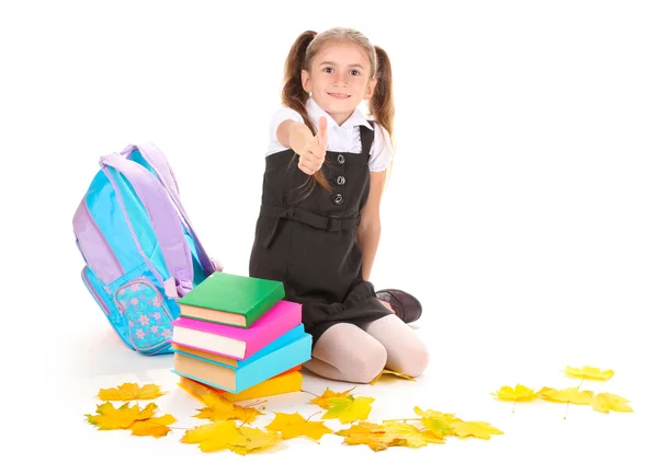 Beautiful little girl, books and a backpack isolated on white — Stock Photo, Image