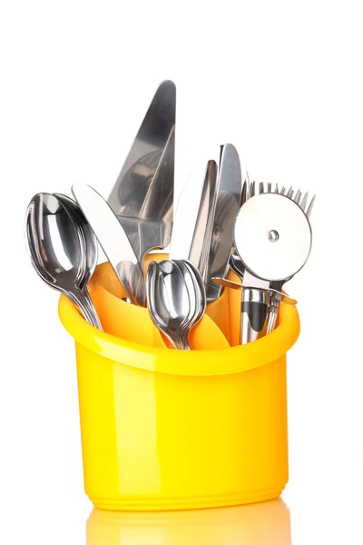 stock image Kitchen cutlery, knives, forks and spoons in yellow stand isolated on white