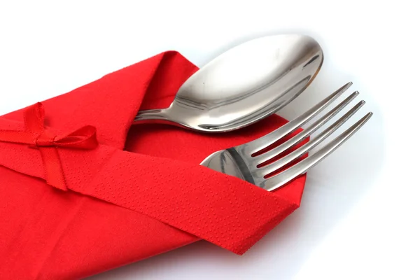 Tenedor y cuchara en un paño rojo con un lazo aislado en blanco —  Fotos de Stock
