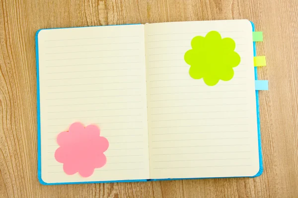 Open note book with stickies on wooden background — Stock Photo, Image
