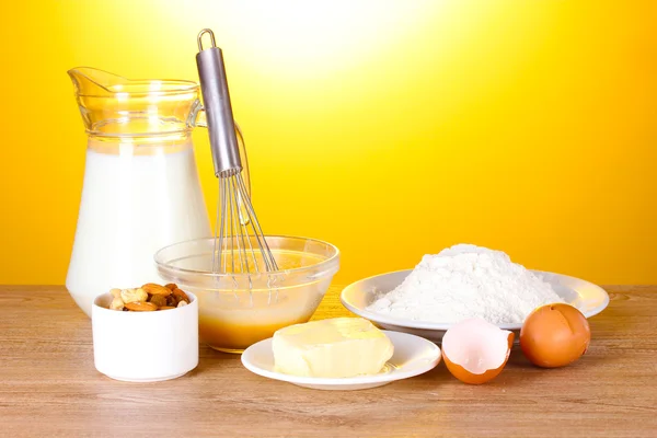 Ingredients for the dough wooden table on yellow background — Stock Photo, Image