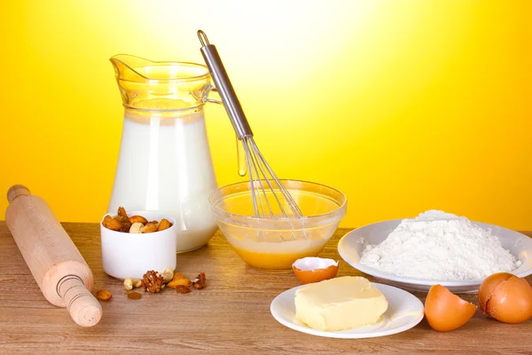 Ingredients for the dough wooden table on yellow background — Stock Photo, Image