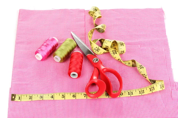Scissors, treads and measuring tape on fabric isolated on white — Stock Photo, Image