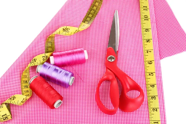 Scissors,threads, measuring tape and pattern on fabric isolated on white — Stock Photo, Image