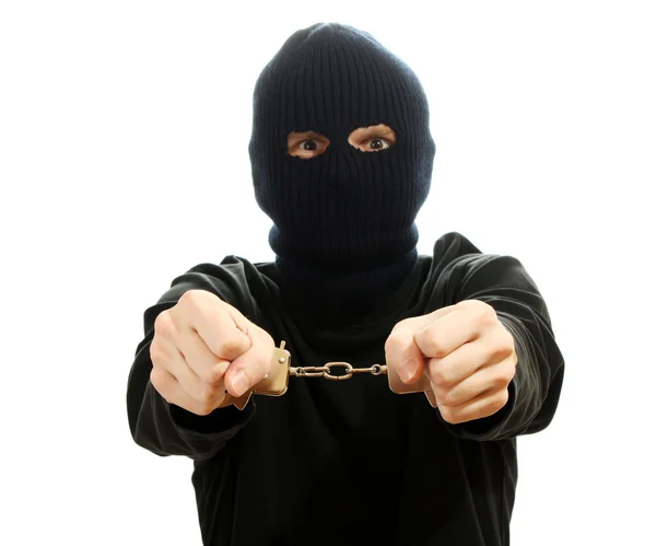 Bandido em máscara preta algemado isolado em branco — Fotografia de Stock