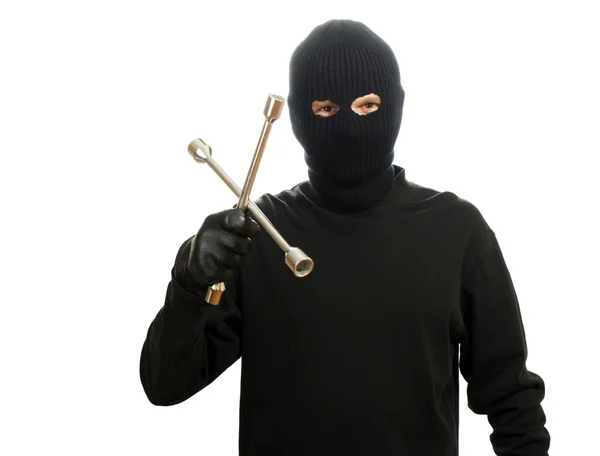 Bandit in zwart masker met wiel moersleutel geïsoleerd op wit — Stockfoto