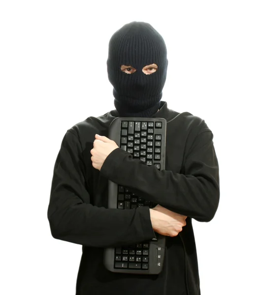 Hacker in schwarzer Maske mit weißer Tastatur — Stockfoto