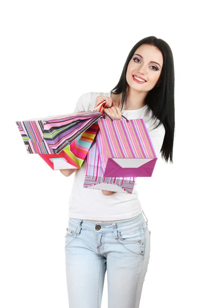 Vacker ung flicka håller ljusa väskor isolerad på vit — Stockfoto
