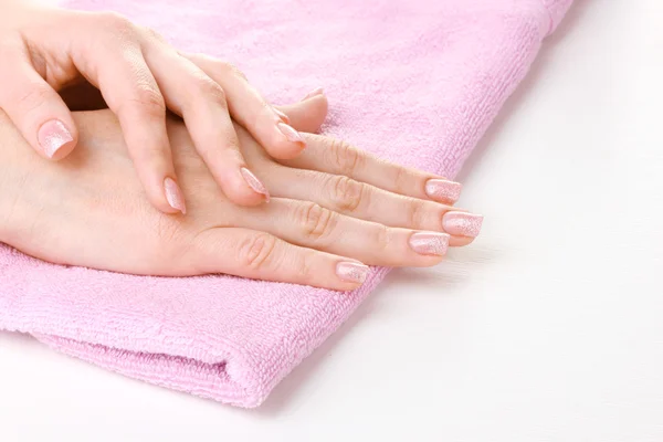 Beautiful women hands on pink towel — Stock Photo, Image