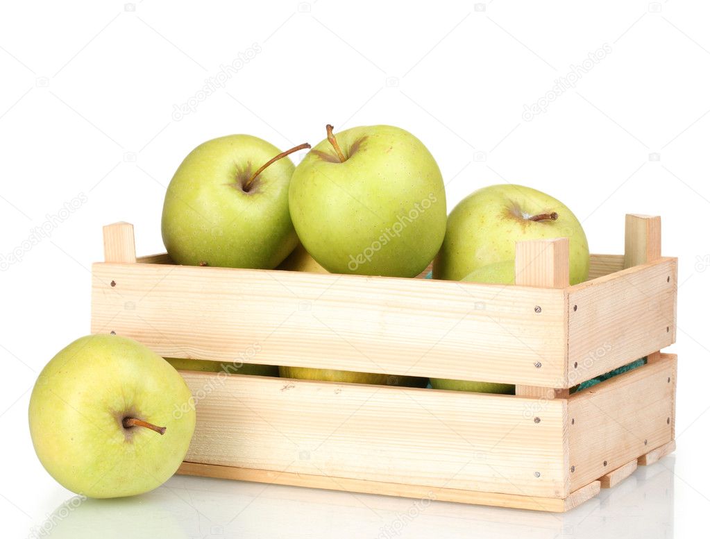 Juicy green apples in a wooden crate isolated on white