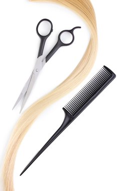 Shiny blond hair with hair cutting shears and comb isolated on white clipart