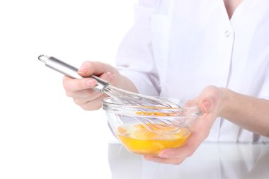 Female hands Mixing eggs in bowl isolated on white clipart