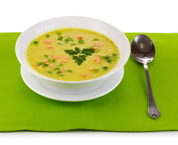 Tasty soup on green tablecloth isolated on white — Stock Photo, Image