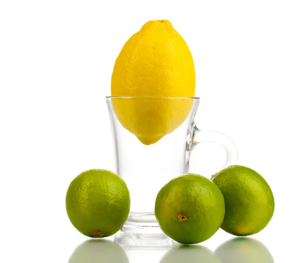 Fresh lemon in glass cup and limes isolated on white — Stock Photo, Image