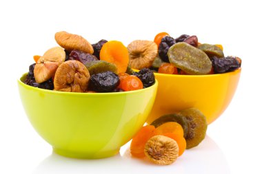 Dried fruits in bright bowls isolated on white