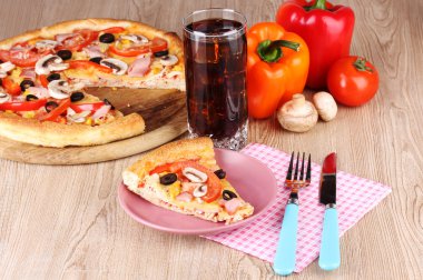 Composition with slice of pizza on plate close-up on wooden background