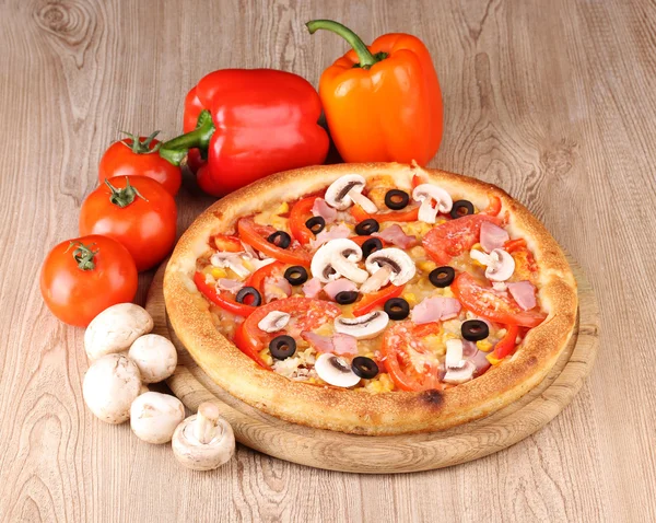 Aromatic pizza with vegetables and mushrooms on wooden background — Stock Photo, Image