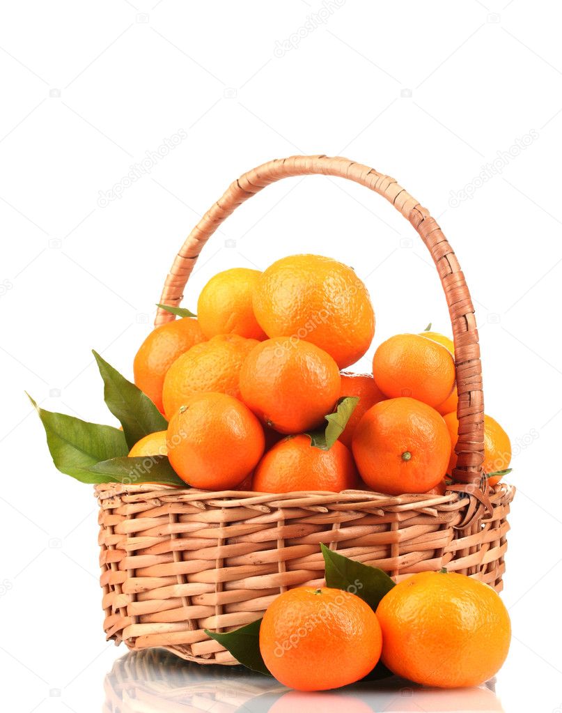 Tangerines with leaves in a beautiful basket isolated on white