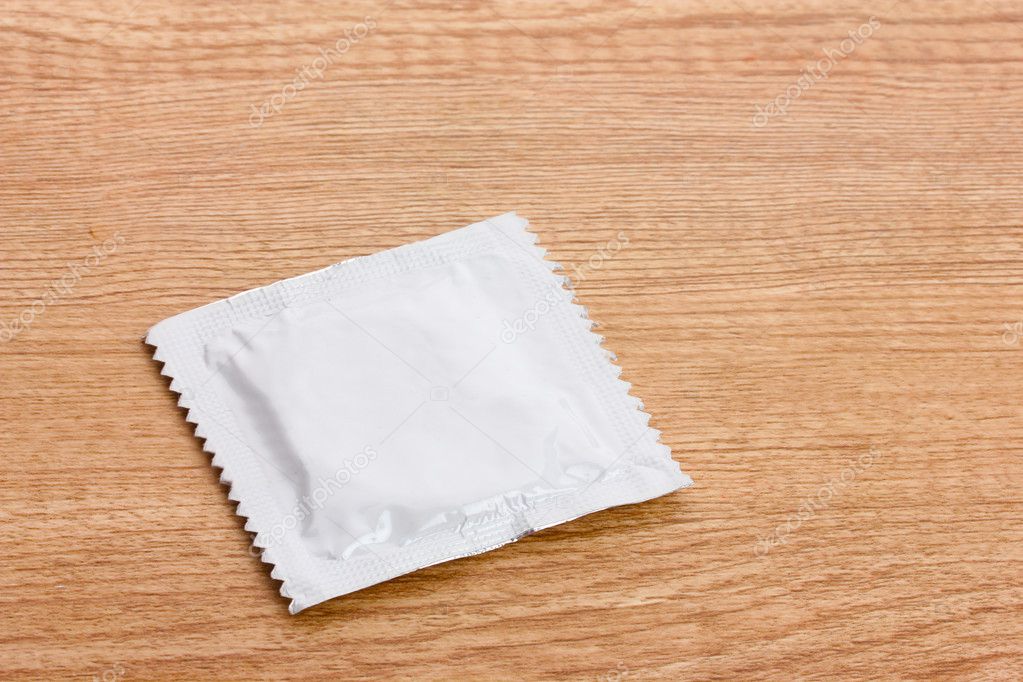 One condom on wooden background