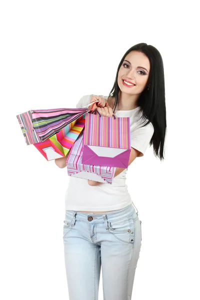Beautiful young girl holding bright bags isolated on white — Stock Photo, Image
